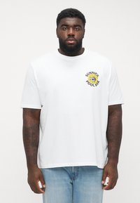 White cotton t-shirt with a round neck and short sleeves, featuring a colorful "SUNNIES POOL BAR" graphic with a sunflower on the chest.