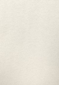 Light beige cotton fabric with a smooth, woven texture. Even surface with no visible patterns or embellishments.
