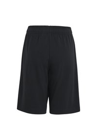 Svarta elastiska idrottshorts med enkel, lös passform visade bakifrån mot en vit bakgrund.