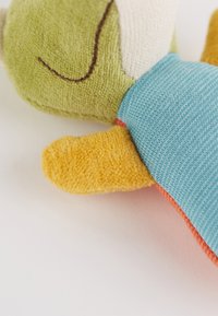 Soft plush toy with a green textured head, yellow fuzzy limbs, and a blue patterned body. Features include orange accents and gentle stitching.