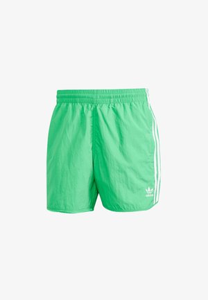 Zelene atletske šortse od laganog materijala, sa elastičnim pojasom, bijelim bočnim prugama i malim logotipom na rubu.