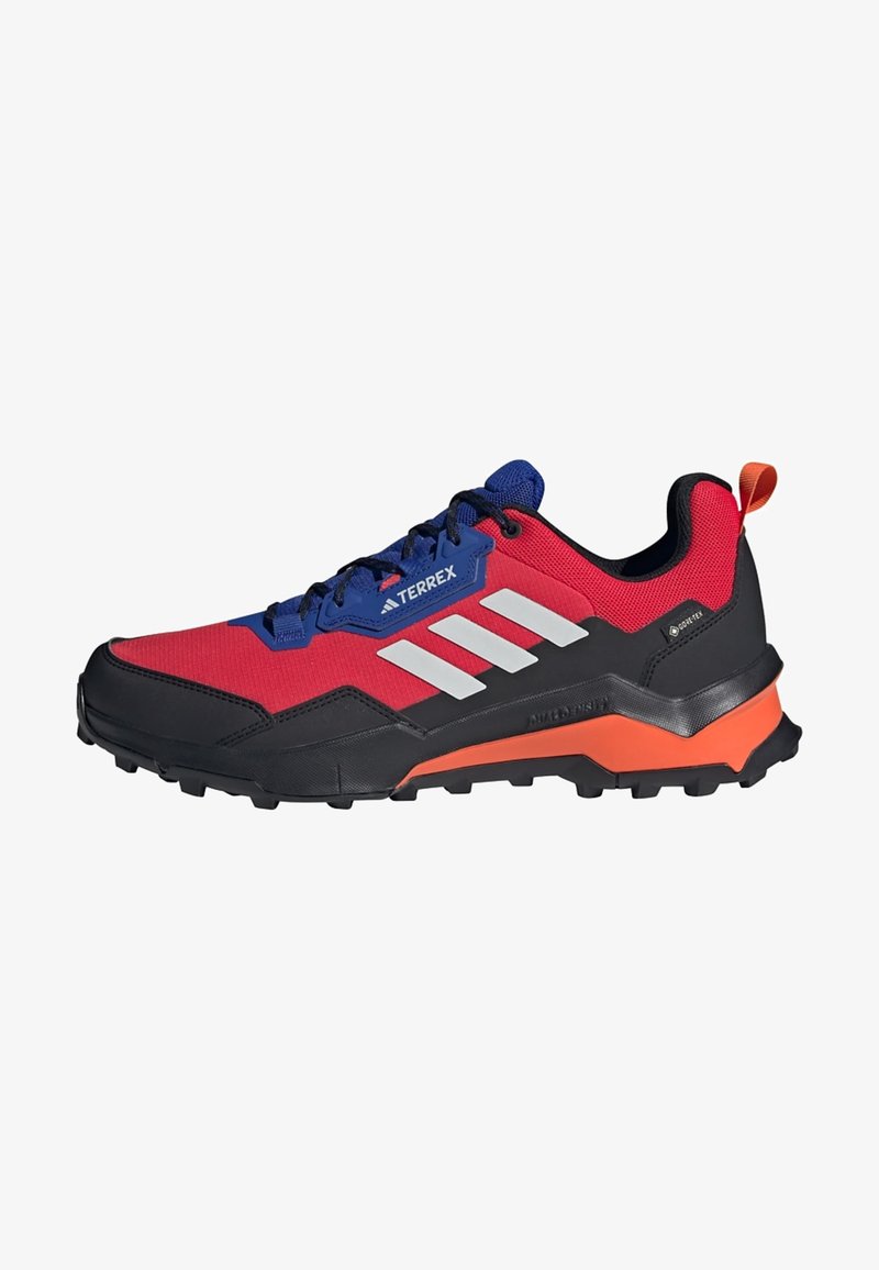 Red and black hiking shoes with blue accents, featuring a textured upper, three white stripes, and a rugged outsole for traction.