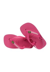Ciabatte Havaianas per bambini di colore rosa brillante, con suole testurizzate e bandiera brasiliana sulle fascette testurizzate.