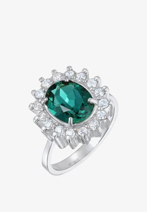 Anillo de plata esterlina con un centro de gema verde ovalada rodeada de pequeñas piedras transparentes, con un acabado pulido y brillante.