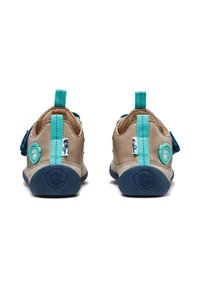 Tan leather shoes with blue rubber soles, turquoise accents, and Velcro strap. Features a looped heel tab and playful branding detail.