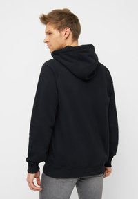 Schwarzer kapuzensweatshirt mit lockerer Passform, gerippten Bündchen und Saum. Glatte Textur und minimalistisches Design, mit einer Kängurutasche.