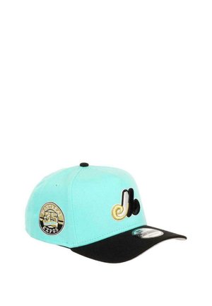 Turquoise baseball cap with black visor, featuring embroidered accents: a gold logo and a circular patch with “Montreal Expos 35.”