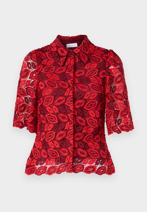 Red lace blouse with short puff sleeves, featuring a leaf pattern and a buttoned front. The texture is sheer and layered with a solid collar.