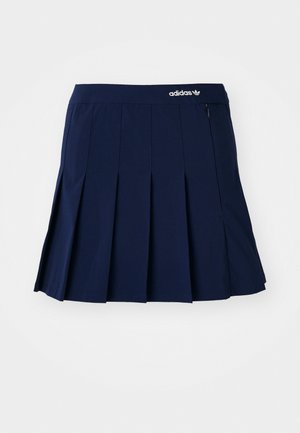 Tumesinine plisseeritud seelik, mis on valmistatud kergest kangast; sisaldab elastset vööd ja väikest lukuga taskut, ees on valge Adidas logo.