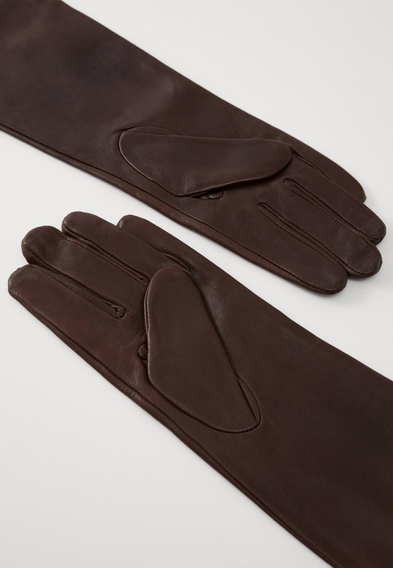 Brown leather gloves with a smooth texture, featuring a unique pointed accent on the backhand and elongated wrist coverage.