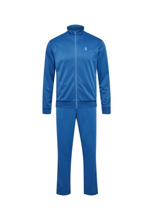 Träningsdräkt i ett enfärgat blått tyg med full zip, hög krage och elastiska muddarna. Har en liten vit logotyp på jackan.