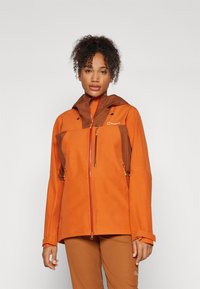 Orange waterproof jacket with brown accents, zipper pockets, adjustable cuffs, and a hood. Smooth texture, designed for outdoor activity.