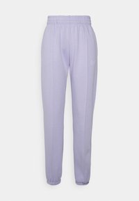 Lilafärgade Nike sweatpants med elastisk midja och fotmanschetter, med en liten vit Nike-swoosh på vänstra låret.