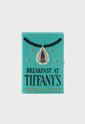 Turquoise book-shaped clutch with black beaded necklace, white pendant, gold stars, and text "Breakfast at Tiffany's Truman Capote."