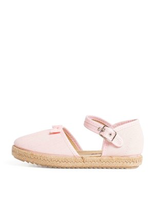 Pink canvas espadrille with a flat, woven jute sole. Features a side buckle and small bow detail on the front. Open design.