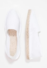 White canvas espadrilles with a jute braided sole, round toe, and elastic side. Features smooth texture and simple design.