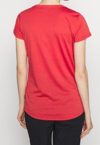 Red short-sleeve t-shirt with a rounded neckline, smooth texture, and a tag near the hem, viewed from the back.