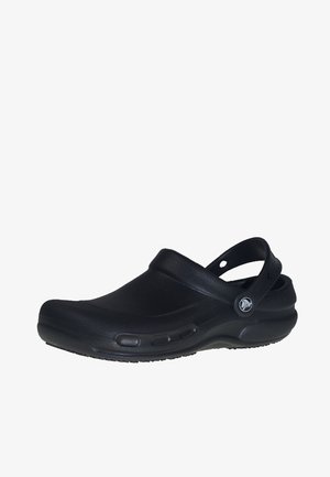 Black clog with a rounded toe, made of textured synthetic material. Features a back strap and ventilation holes on the sides. Lightweight design.