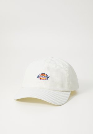 White corduroy cap with curved brim, featuring an embroidered multicolored logo on the front. Textured fabric and standard fit.