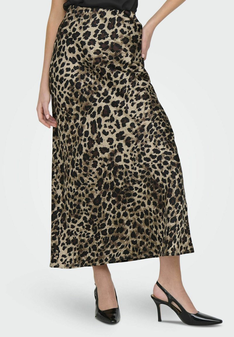 Gonna maxi in satin con stampa leopardata e vita alta, caratterizzata da una texture liscia e un taglio dritto, abbinata a décolleté nere con cinturino sul retro.