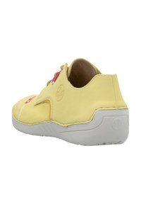 Geel leren sneaker met roze veters, witte stiksels en een gestructureerde grijze zool. Gebogen ontwerp en uitsnijding aan de zijkant.