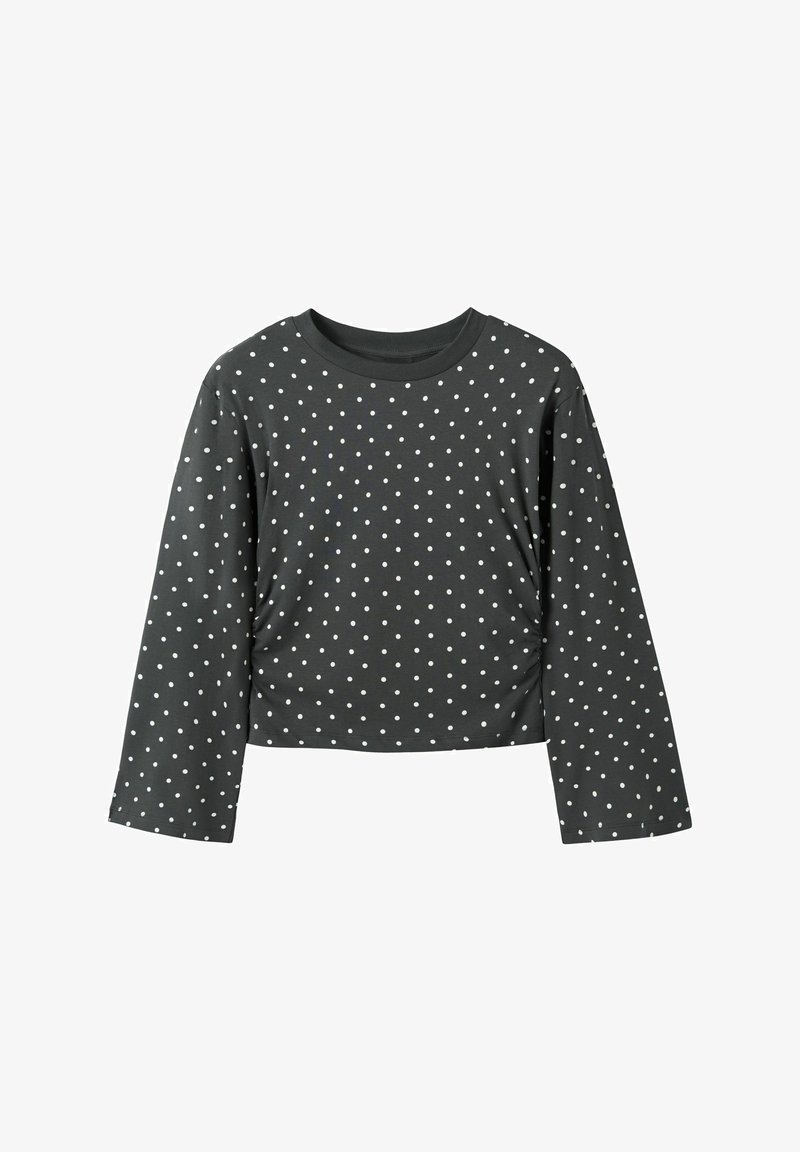 Lange mouwen, cropped top van donkergrijze stof met witte stippen. Heeft een ronde halslijn en een losse pasvorm met eenvoudige stiksel-details.