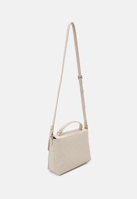 Beige kabelka s vzorovaným povrchem, s horním držadlem a nastavitelným ramenním popruhem. Vyrobena z syntetického materiálu.