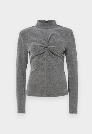Camisola de gola alta de manga longa em preto e branco com padrão texturizado, apresentando um detalhe de nó na parte da frente e uma silhueta justa.