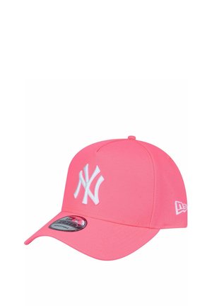Pink cap featuring a structured design, white New York Yankees logo, curved brim, and textured fabric. Includes logo sticker on the visor.
