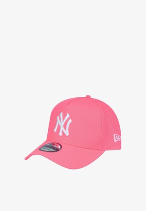 Pink cap featuring a structured design, white New York Yankees logo, curved brim, and textured fabric. Includes logo sticker on the visor.