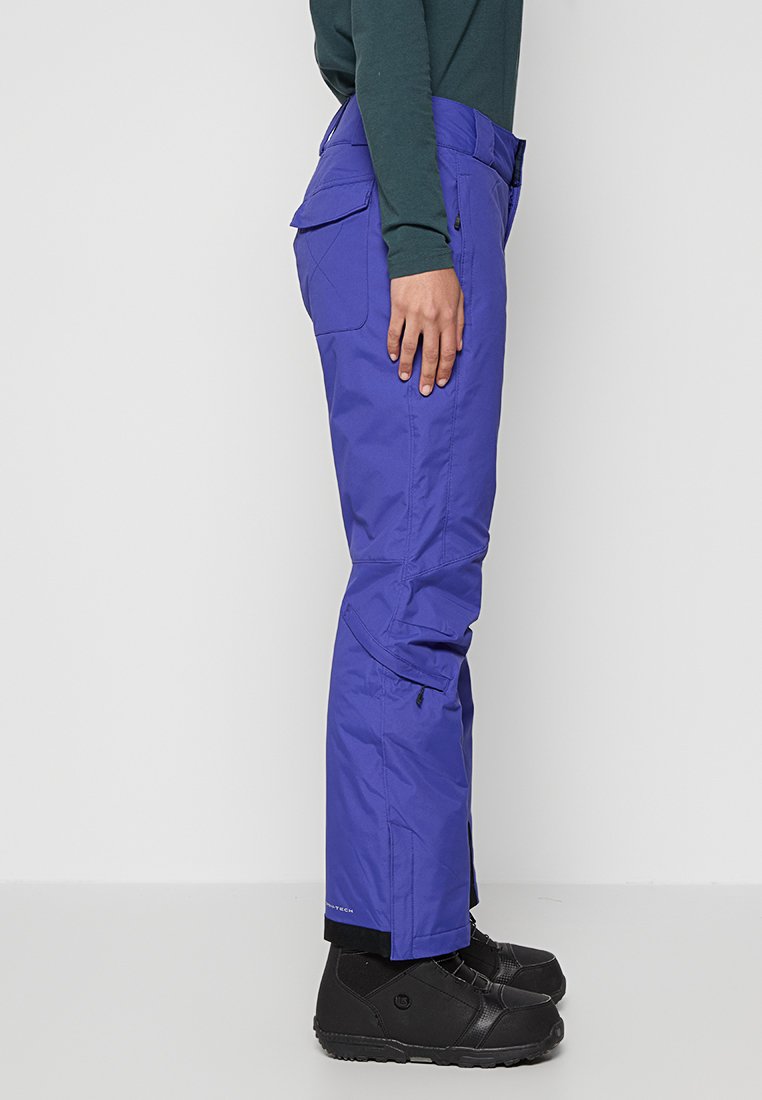 Pantaloni da neve impermeabili viola con tasche laterali, polsini regolabili e ginocchia articolate, realizzati in tessuto durevole, adatti per il freddo.