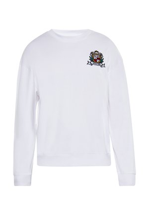 Witte sweatshirt met lange mouwen, ronde hals en een geborduurd embleem op de linkerborst, met groene en rode accenten.