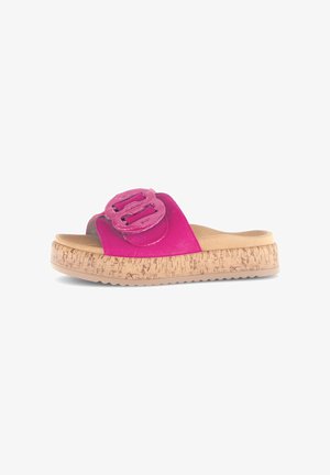 Pink slide sandals with a glossy, wide strap featuring double buckle accents. Cork-textured outsole with a beige grip sole.