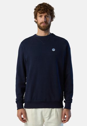 Felpa blu navy con maniche lunghe, collo a giro, polsini e orlo a coste, con un piccolo logo circolare sul petto. Texture morbida.