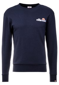 Marinblå sweatshirt i mjuk bomull, med rund halsringning, långa ärmar, ribbade manschetter och nederkant, samt en vit broderad logotyp på bröstet.