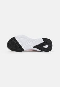 Sola della scarpa in bianco e nero con motivi in gomma testurizzata. Presenta un accento rosa e un logo sul lato per una maggiore aderenza e supporto.