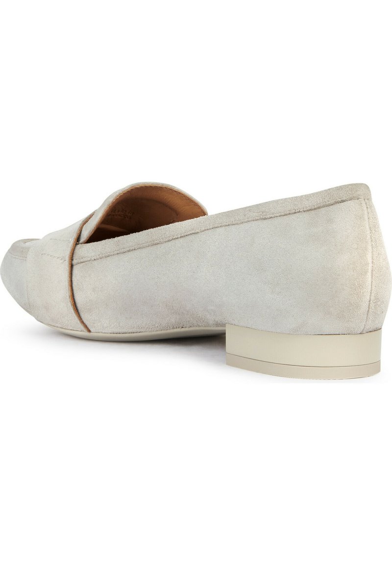 Scarpa slip-on in camoscio beige chiaro con punta arrotondata e cuciture minime. Tacco basso a blocco con suola liscia di colore chiaro.