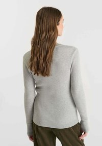 Gray ribbed long-sleeve sweater featuring a fitted design and wide cuffs, shown from the back with medium-length hair visible.