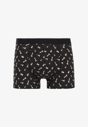 Mustad mustriga mustad pokkeripüksid, millel on kreemivärvi malefiguuride korduv muster. Valmistatud pehmest kangast ja mugava vöökohtadega.