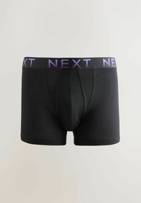 Boxer shorts negros hechos de un material suave y elástico, con una cinturilla de logo "NEXT" en color morado y un diseño de bolsa frontal contorneado.