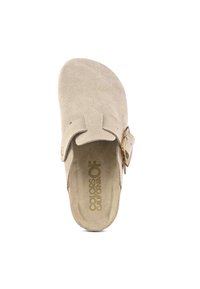 Beige suede clog with a rounded toe, adjustable buckle strap, and textured insole. Smooth exterior with minimal stitching detail.