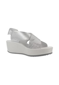 Sandalias de cuña plateadas con correas de textura entrelazadas, parte trasera elástica y suela de plataforma blanca. Presenta una suela de goma gris resistente.