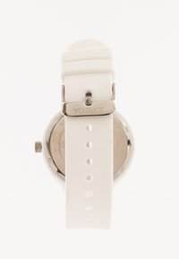 White silicone wristwatch with a round case and silver hardware, featuring a smooth texture and multi-hole strap for adjustable fit.