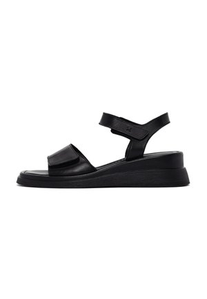 Black leather sandals featuring a wide front strap, adjustable ankle strap, and a low wedge sole for added support and comfort.