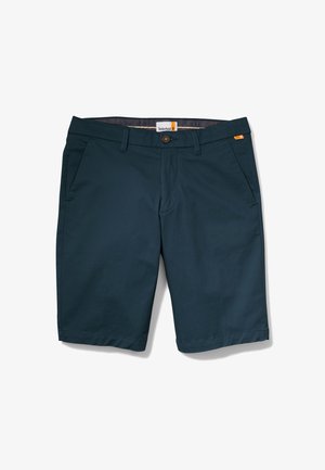 Mörkblå shorts i lättviktsmaterial, med två sidofickor, framknäppning och söm i nederkant. Timberland-märket ingår.