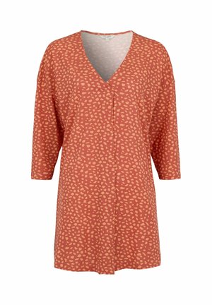 Rust orange tunic with light peach irregular dot pattern, V-neckline, and elbow-length sleeves.