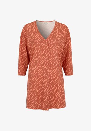 Rust orange tunic with light peach irregular dot pattern, V-neckline, and elbow-length sleeves.