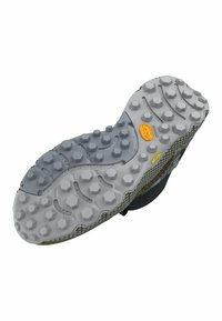 Shoe outsole with a textured gray rubber surface, featuring hexagonal and rounded traction lugs. Yellow branding visible on the side.