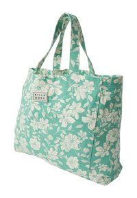 Kvetinová taška na rameno v tyrkysovej farbe s bielymi kvetinovými vzormi, vyrobená z látky; má dve pevné rukoväte a malú značkovú etiketu na boku.