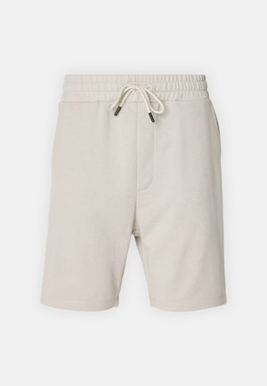 Svetlo béžové bavlnené šortky s elastickým pásom, nastaviteľnou šnúrkou, bočnými vreckami a rovnom strihom. Hladká textúra, bez vzorov.